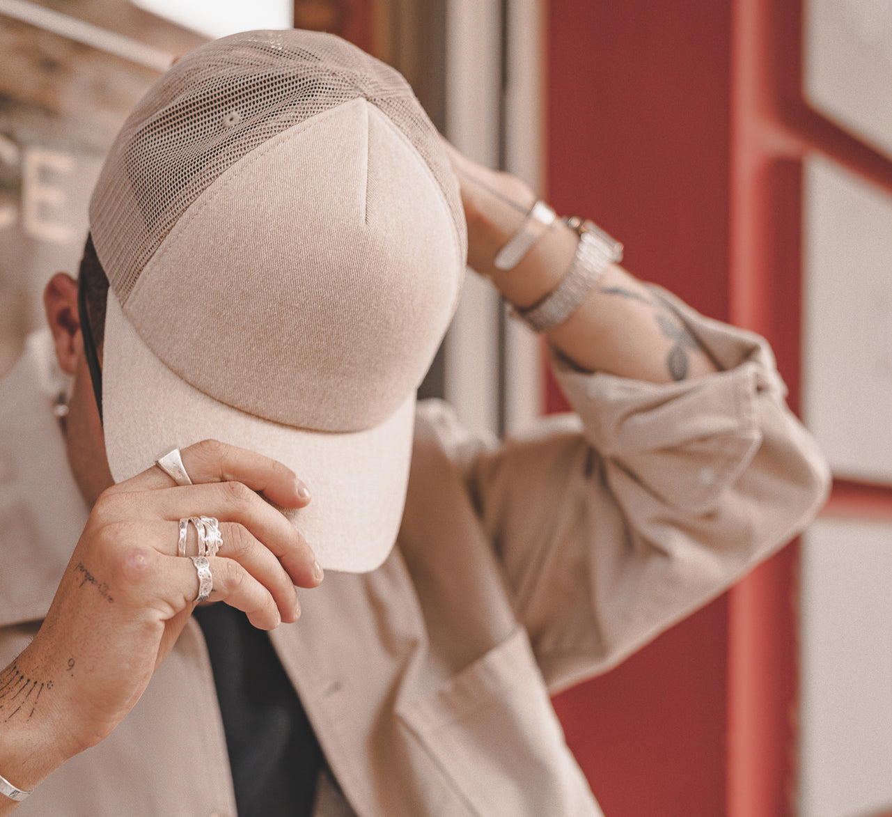 Close-up of man sitting on bench with trucker cap